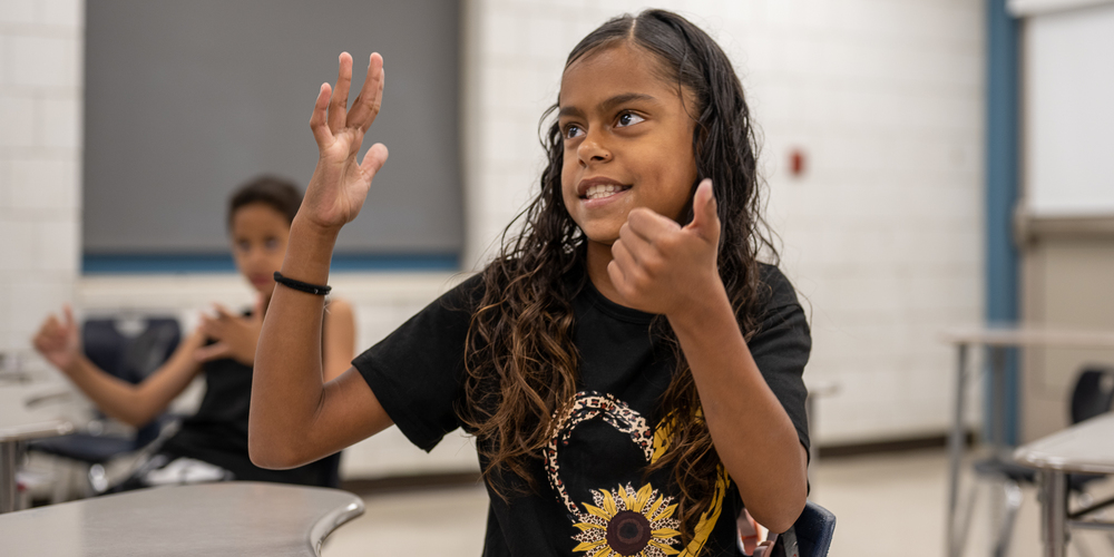 Student at Morgan School Counting With her Hand 
