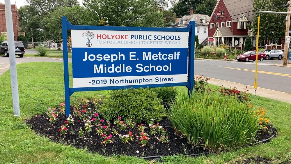Joseph E. Metcalf Middle School street sign placed in flower bed