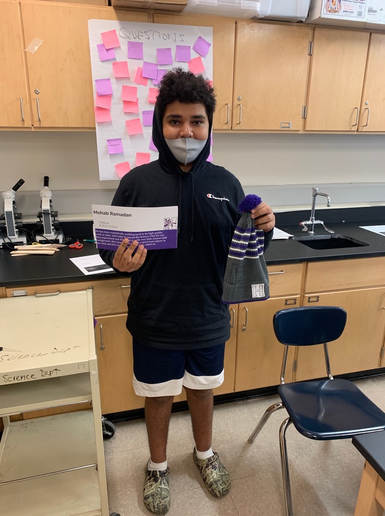 Holyoke High School student Mohab Ramadan posing with certificate and winter hat in classroom.