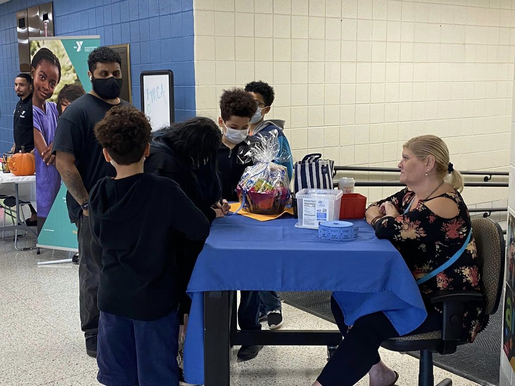 Students checking-in at a table at Kelly School.