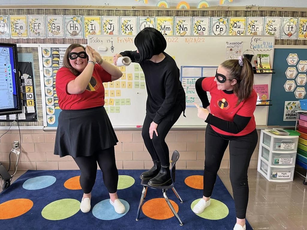 Educators in classroom in their halloween costumes.