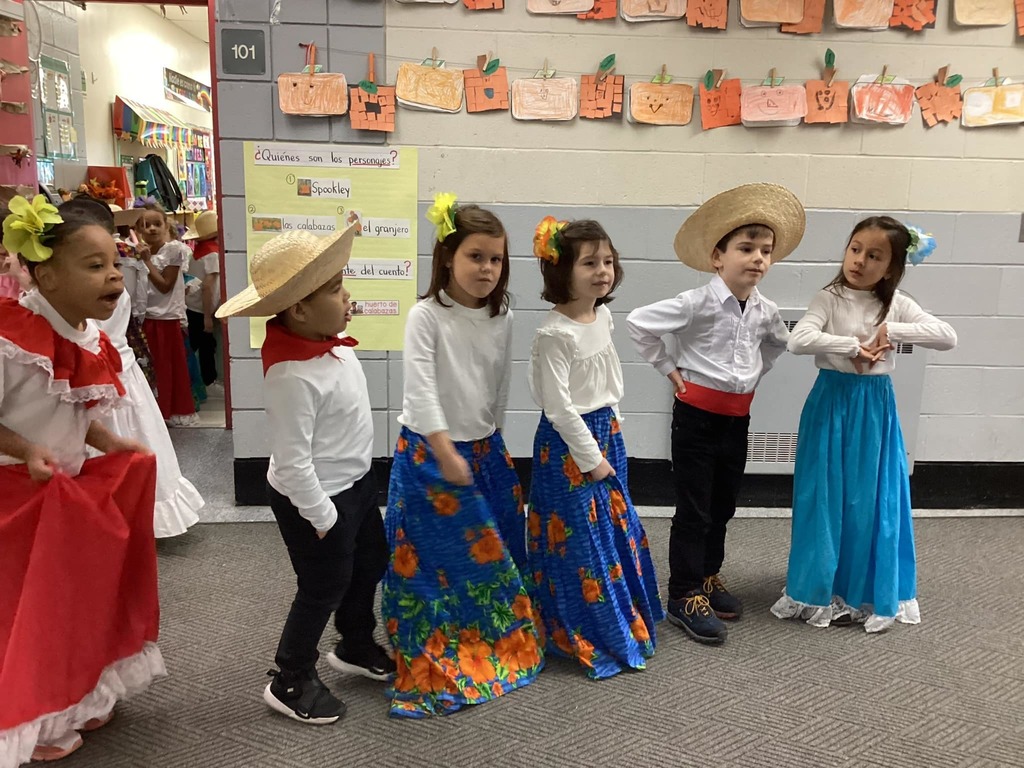 Group of six young students dressed in traditional Puerto Rican clothes.