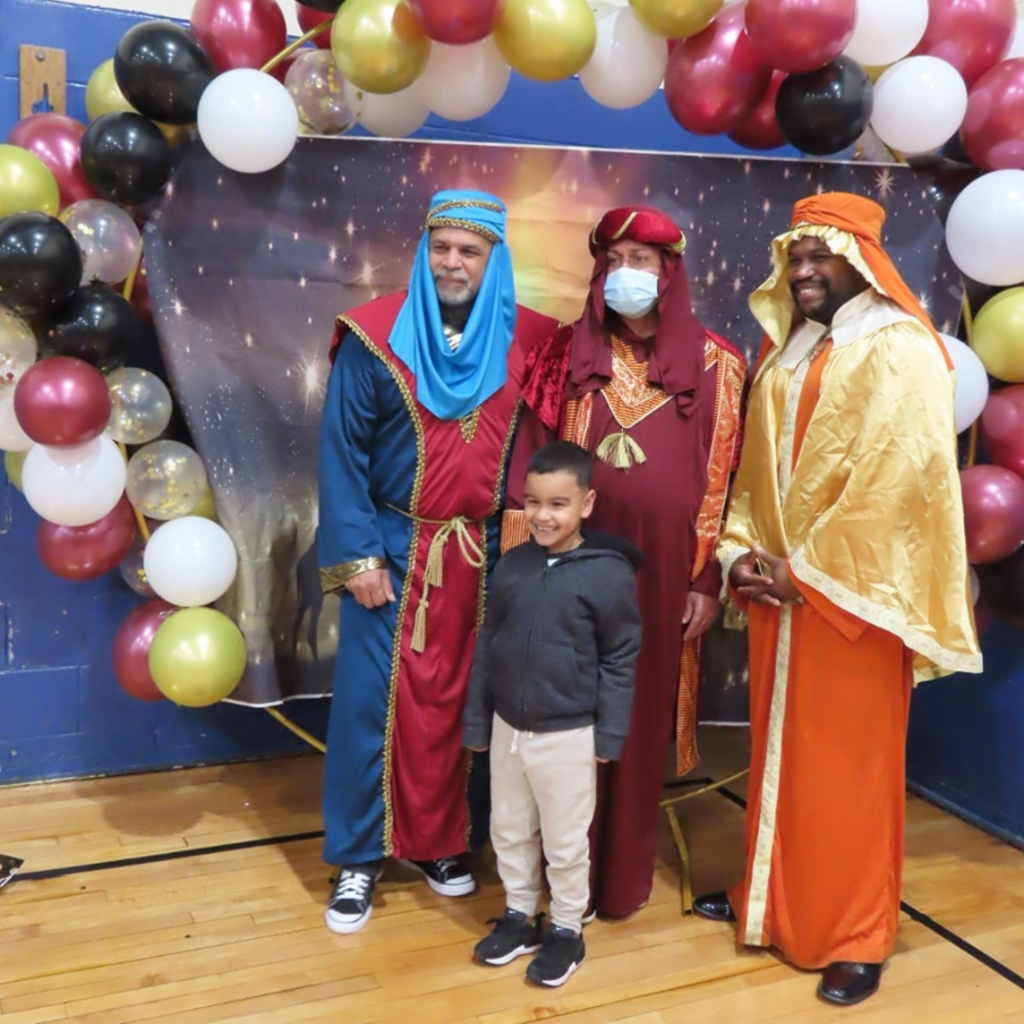 Staff pose for Three Kings Day Celebration at Morgan School.
