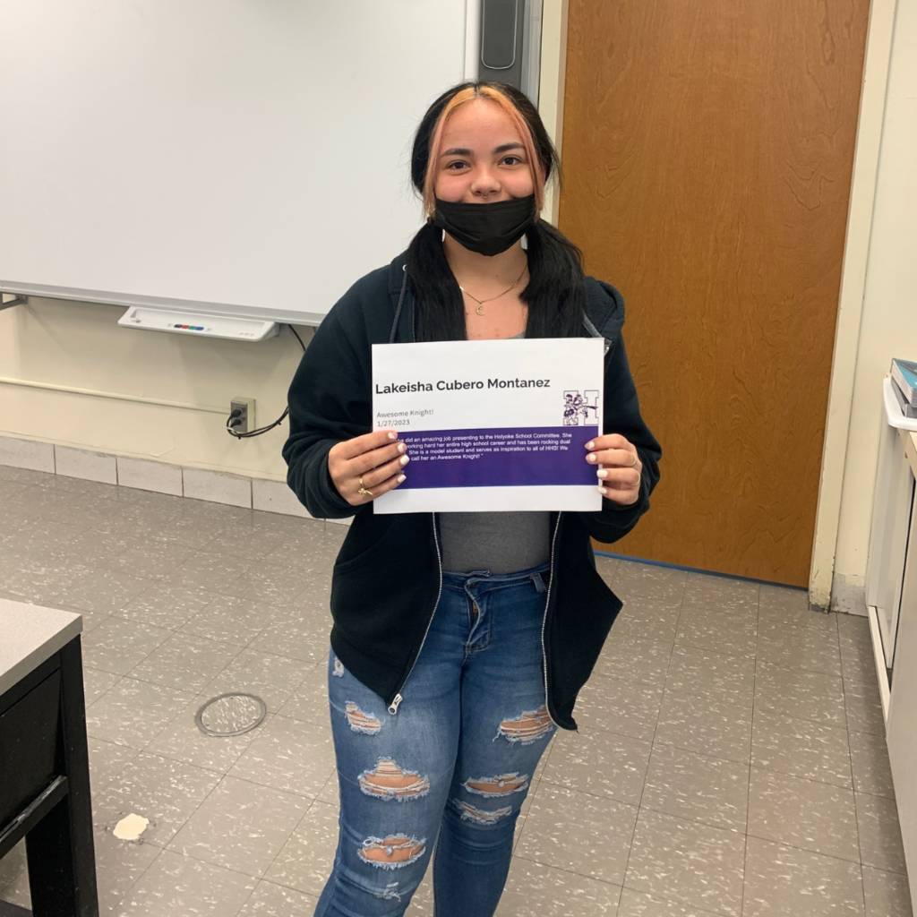Lakeisha Cubero in a classroom holding the awesome knight certificate 