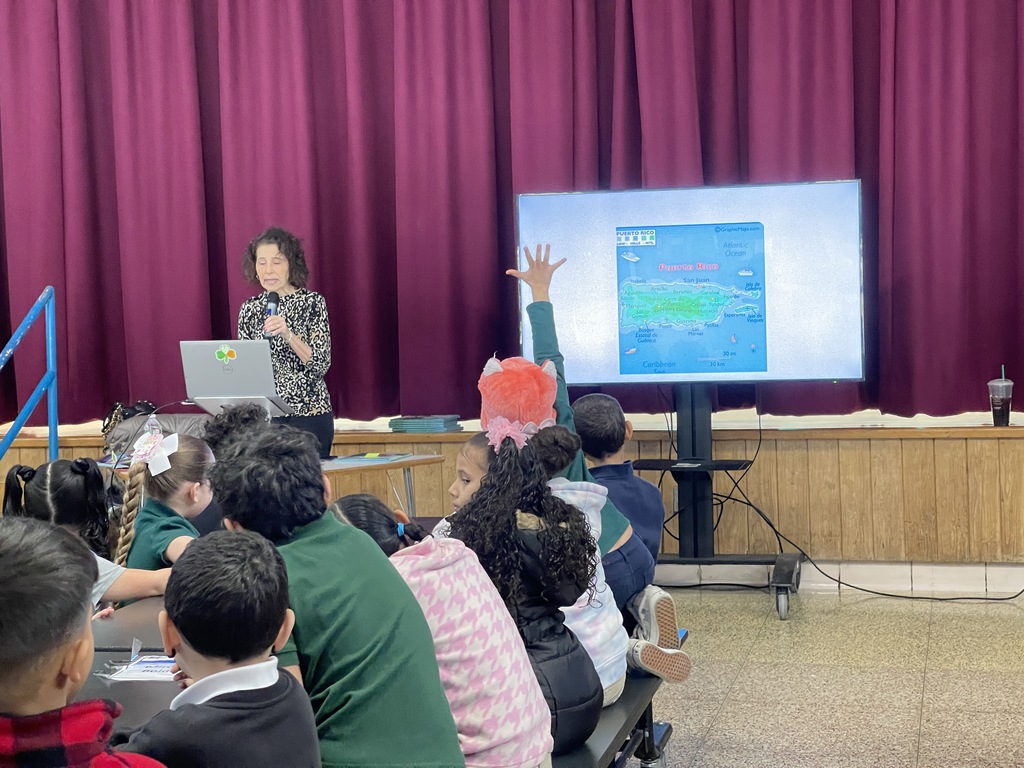 Students from Sullivan School enjoy reading the book Alicia and the Hurricane, A Story of Puerto Rico