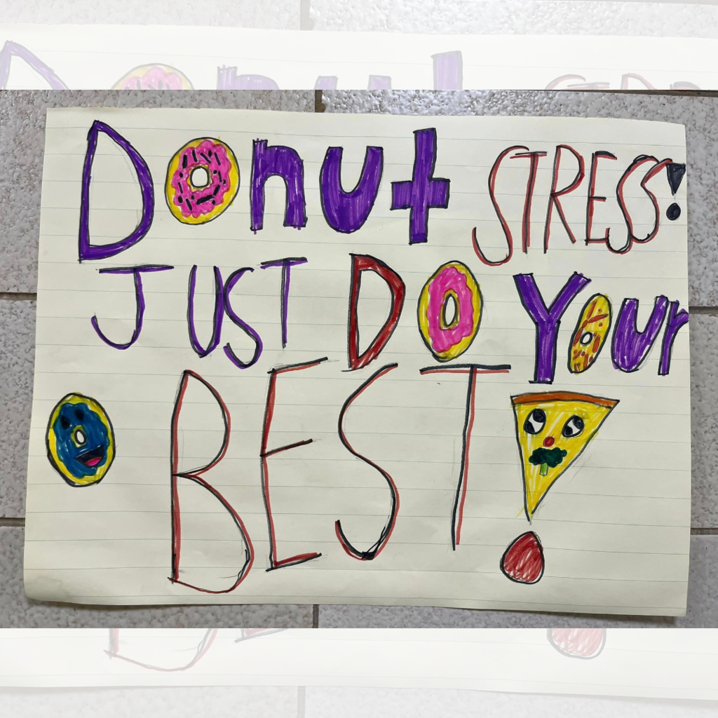 A poster with the words "Donut stress! Just do your best!" with the O drawn as donuts and the exclamation point as a pizza.
